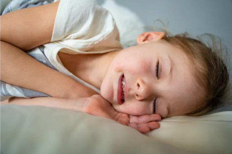 A child with a clenched jaw, grinding her teeth while sleeping.