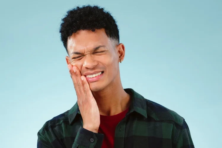 Man suffering from TMJ pain