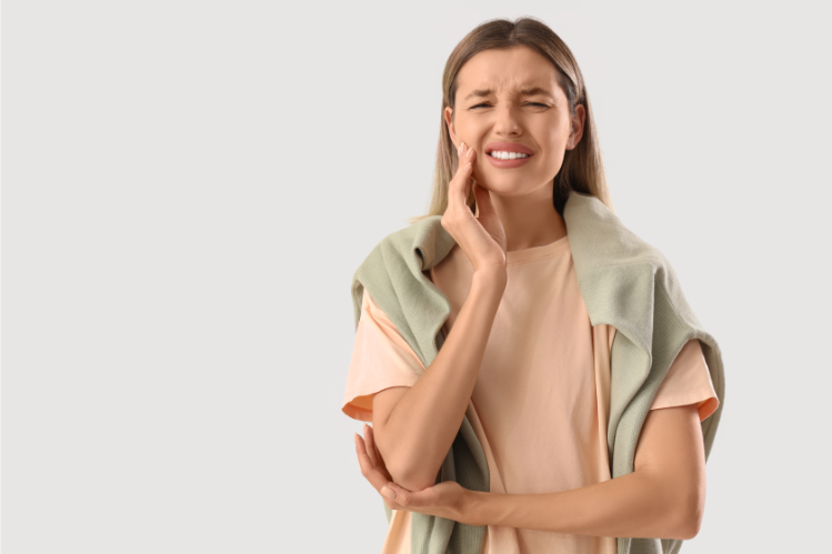 A girl is suffering from a toothache.