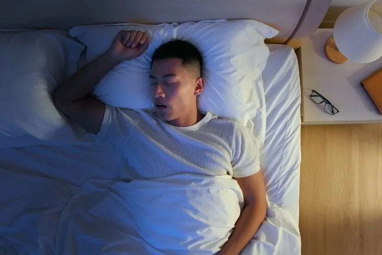 A man sleeping while wearing mouth guards 