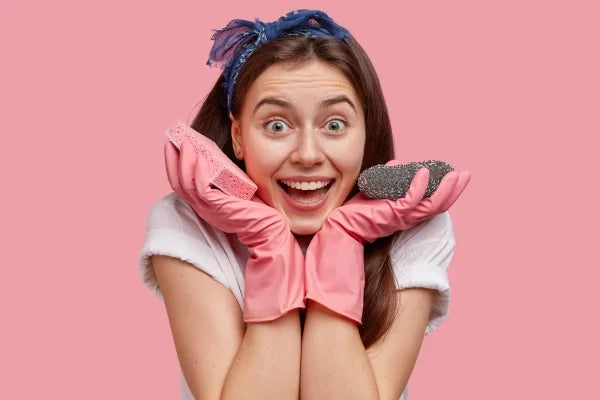 A woman holding sponges to clean retainers