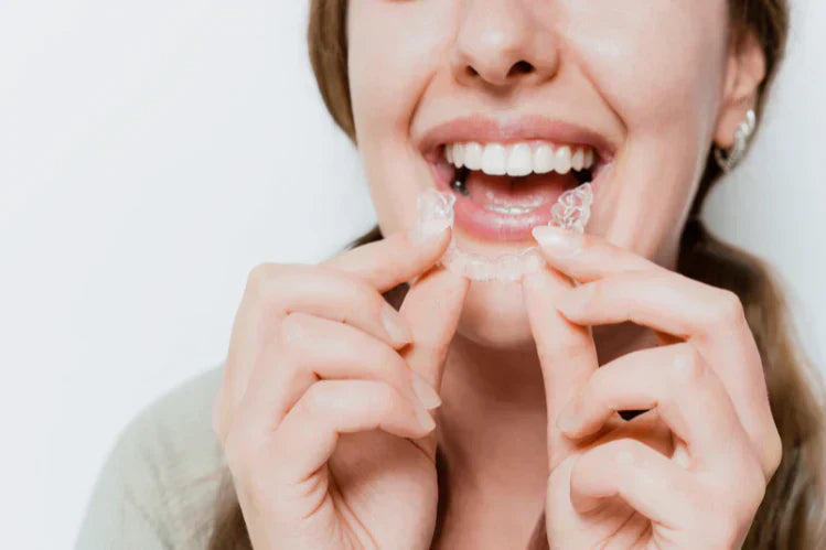 A woman wearing clear aligners. 