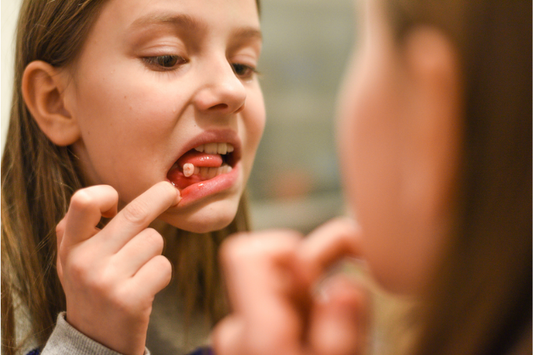 A girl with a loose tooth
