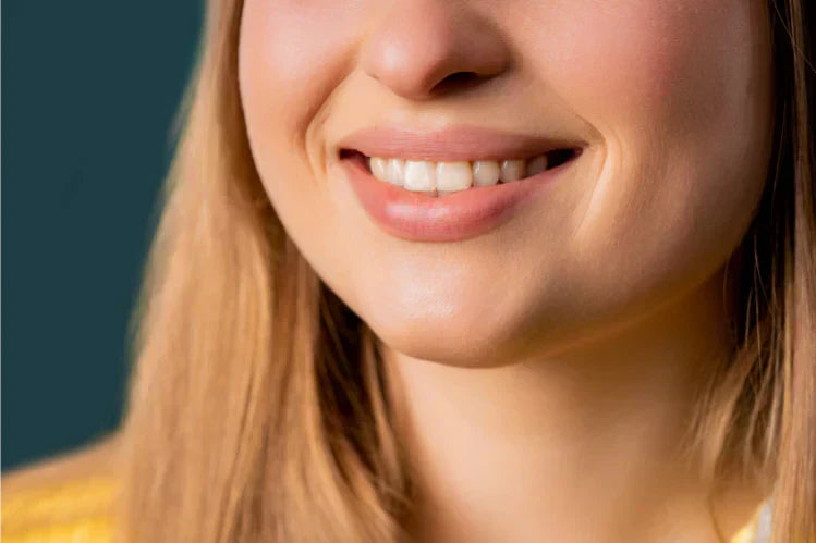 A girl smiles to show her perfect smile