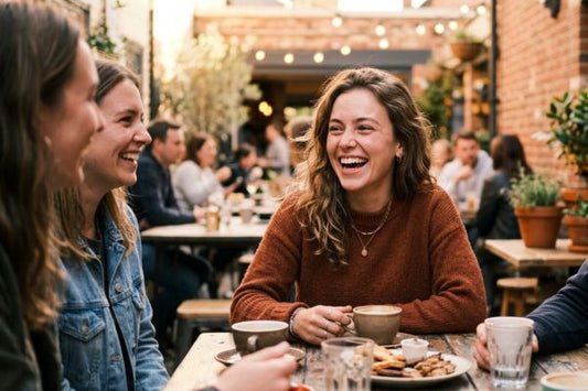 A young woman laughing naturally, with her straight teeth conveying social ease.