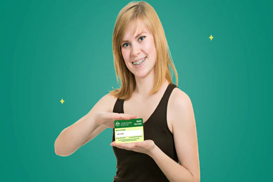 A woman with braces on her teeth, holding a healthcare card