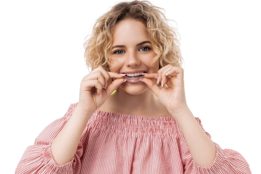 A woman wearing aligners