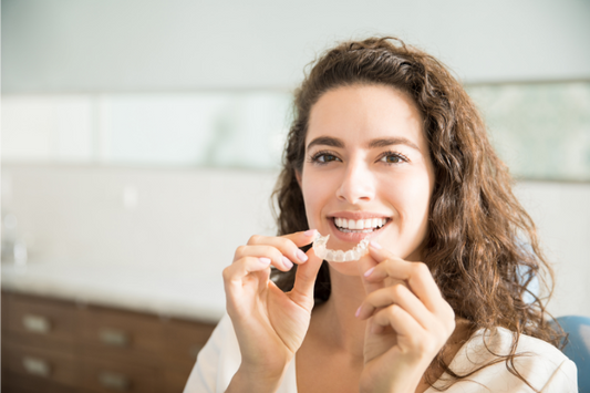 A woman wearing clear aligners