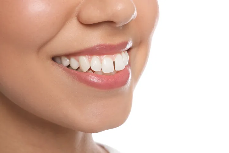 A closeup of a girl with a minor tooth gap.