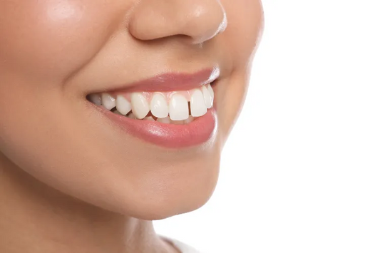 A closeup of a girl with a minor tooth gap.