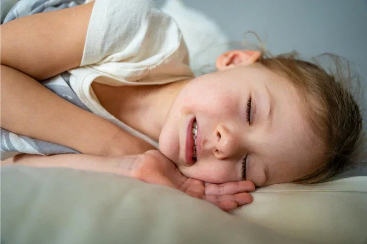 A girl child grinding her teeth in her sleep