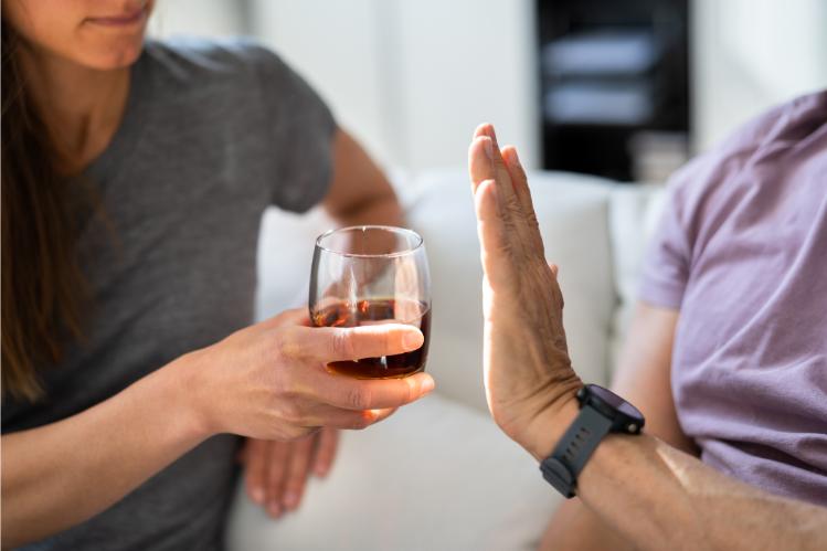 Someone turning down a drink.