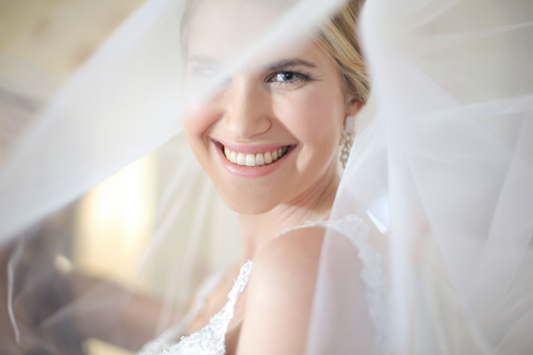 A Beautiful Smiling Bride getting a close-up wedding shot.