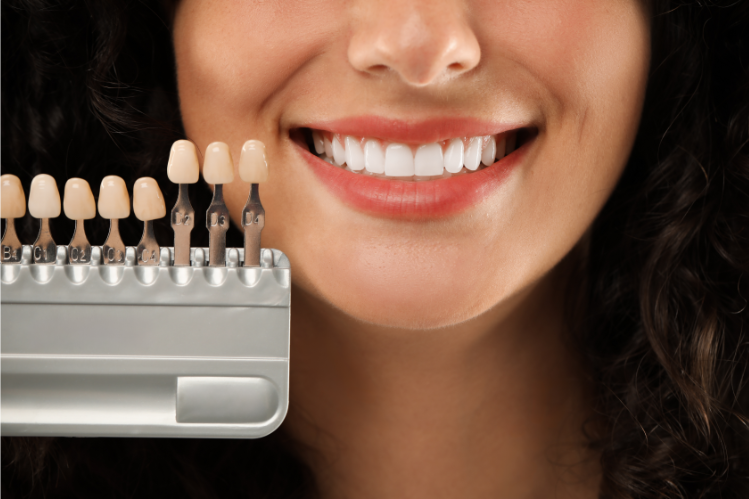 A girl smiling and holding a veneer sample 