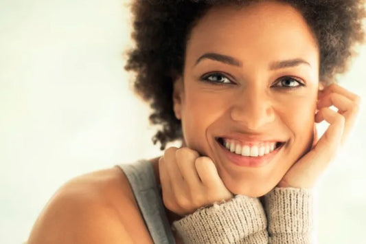 An adult woman smiling with her permanent teeth