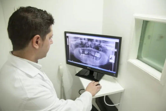 A dentist examining a dental scan for proper clear aligner treatment