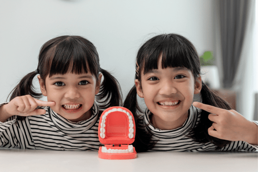 Little girls smiling and showing their teeth